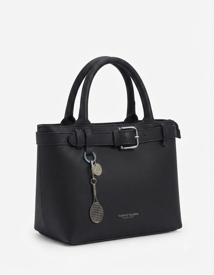 A black pebbled leather handbag with double top handles, a top zipper, a front strap detail with a silver buckle, and a hanging silver tennis racket charm, shown on a light gray background.