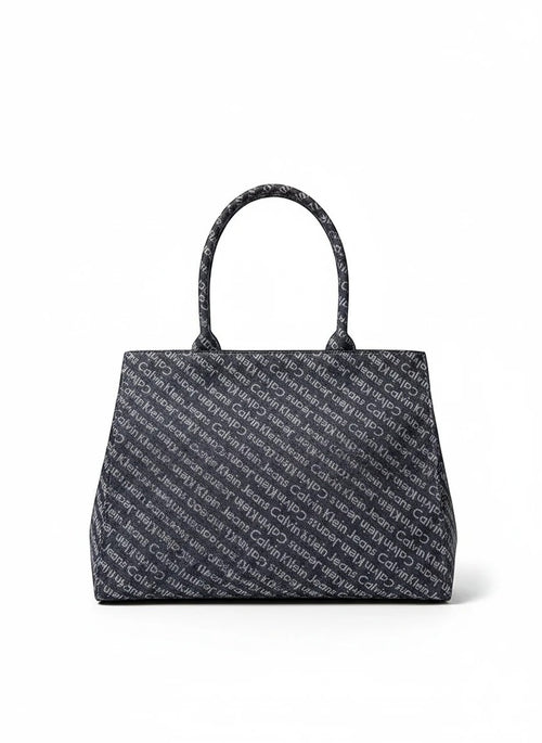 My Store 4 Calvin Klein Jeans navy denim tote bag with all-over white logo print and sturdy top handles.